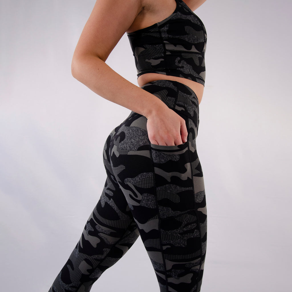 Woman wearing gym patterned leggings with side pockets and high waist in black Camouflage print